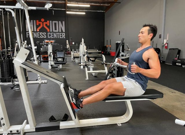 trainer demonstrating seated row to reverse aging